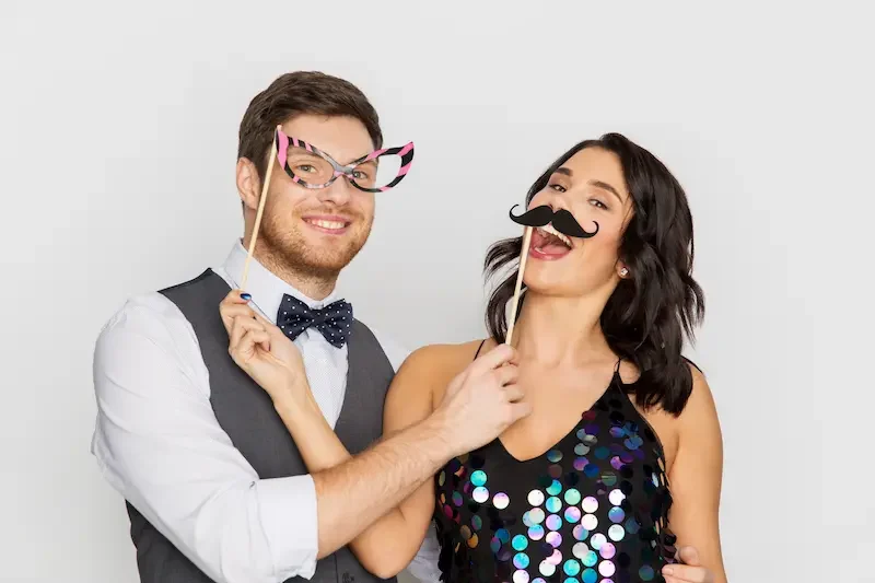 celebration-fun-holidays-concept-happy-couple-posing-with-party-props celebration-fun-holidays-concept-happy-couple-posing-with-party-props